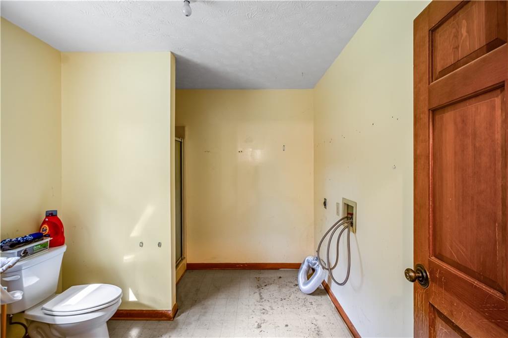 2177 Brooks Road Southeast Dacula, GA 30019 - Photo 16 of 42 a view of bathroom with a shower and toilet