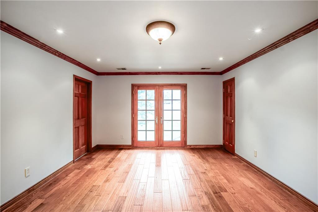 2177 Brooks Road Southeast Dacula, GA 30019 - Photo 17 of 42 an empty room with wooden floor and windows