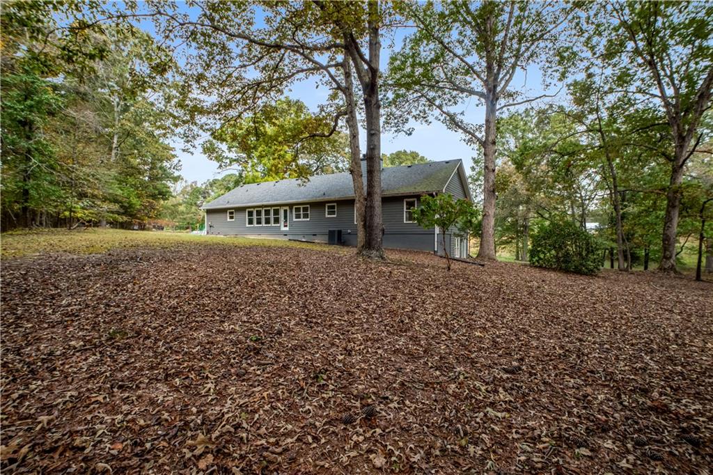 2177 Brooks Road Southeast Dacula, GA 30019 - Photo 5 of 42 a view of a street with trees and bushes