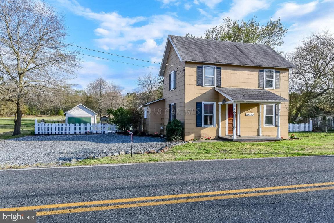 28253 Riverside Drive Salisbury, MD 21801 - Photo 1 of 22 a front view of a house with a yard and garage
