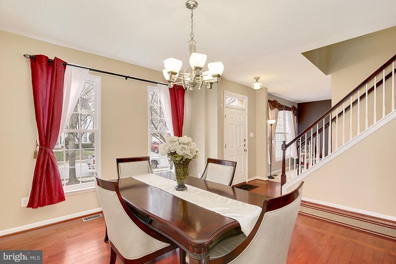 3036 Old Channel Road Laurel, MD 20724 - Photo 11 of 30 a view of a dining room with furniture wooden floor and a chandelier