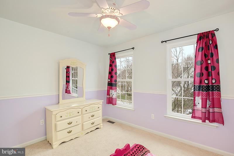 3036 Old Channel Road Laurel, MD 20724 - Photo 13 of 30 a bedroom with a bed and a chandelier