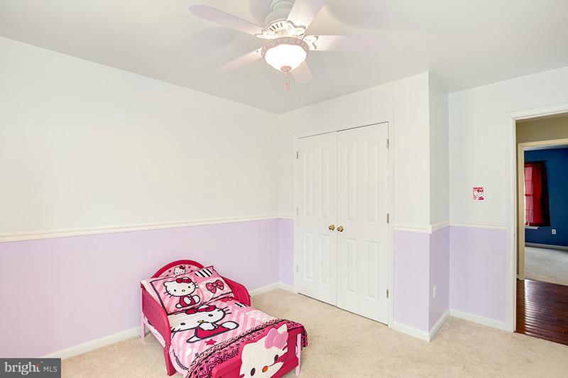 3036 Old Channel Road Laurel, MD 20724 - Photo 14 of 30 a bedroom with a bed and a chandelier