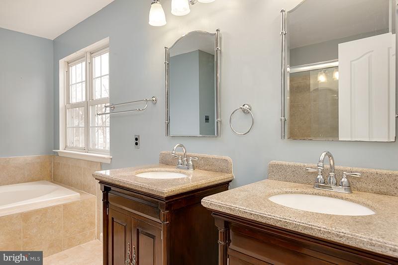 3036 Old Channel Road Laurel, MD 20724 - Photo 22 of 30 a bathroom with double vanity sinks and a mirror