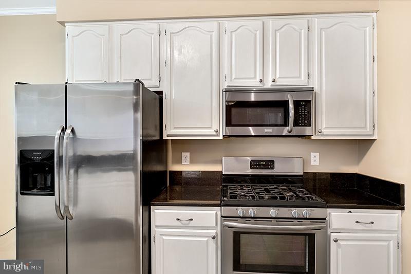 3036 Old Channel Road Laurel, MD 20724 - Photo 8 of 30 a kitchen with stainless steel appliances granite countertop a stove a refrigerator and a microwave