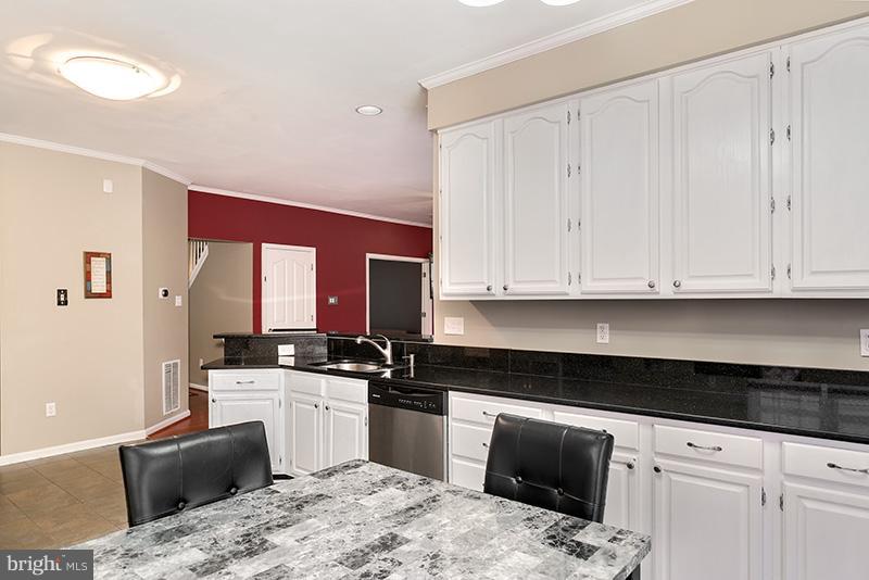 3036 Old Channel Road Laurel, MD 20724 - Photo 9 of 30 a kitchen with granite countertop a sink a stove and cabinets