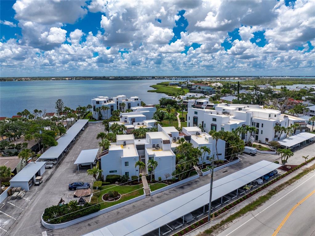 2955 North Beach Road, Unit B614 Englewood, FL 34223 - Photo 53 of 67 a view of a city with lots of residential buildings ocean and mountain in the back