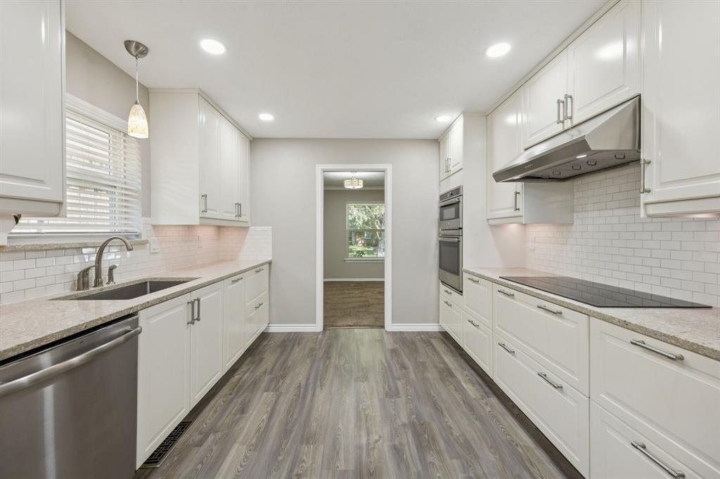 9536 Millridge Drive Dallas, TX 75243 - Photo 12 of 33 a large kitchen with granite countertop a large counter top a sink stainless steel appliances and cabinets