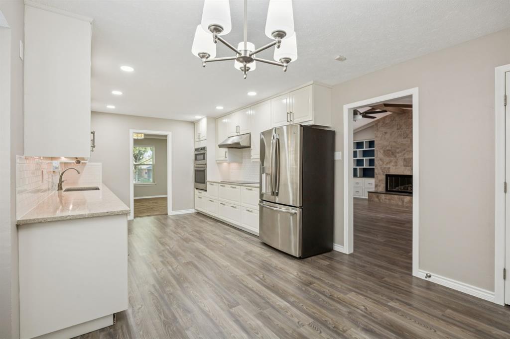 9536 Millridge Drive Dallas, TX 75243 - Photo 13 of 33 a kitchen with stainless steel appliances a refrigerator and a sink