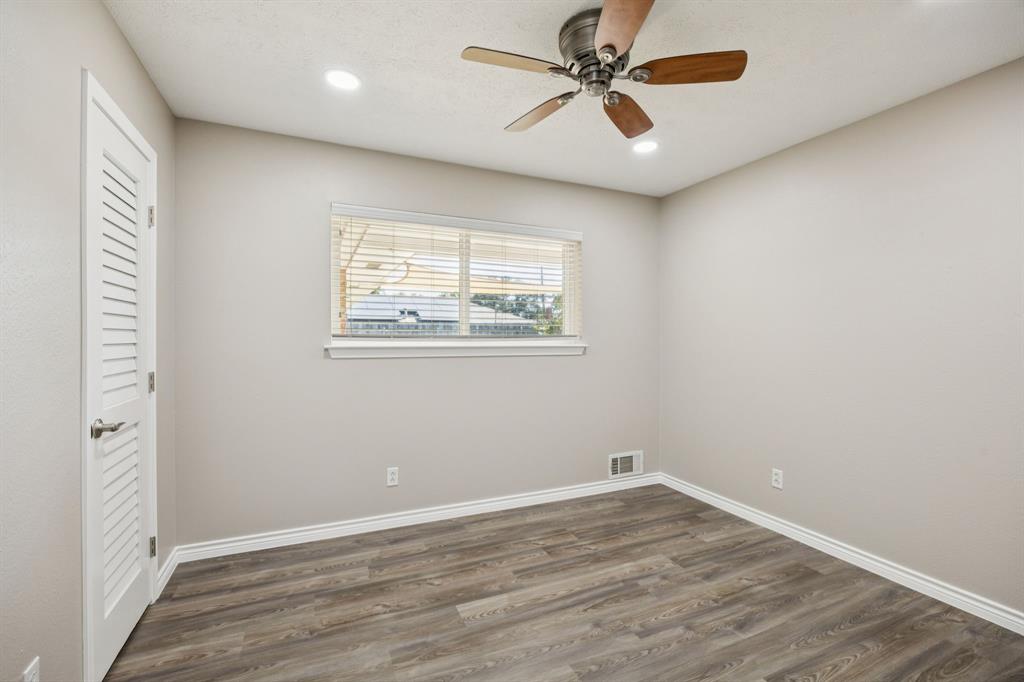 9536 Millridge Drive Dallas, TX 75243 - Photo 19 of 33 wooden floor in an empty room with a window