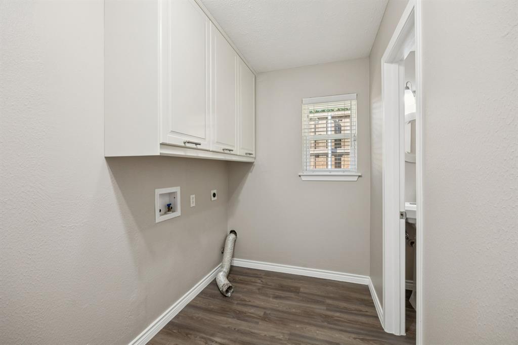 9536 Millridge Drive Dallas, TX 75243 - Photo 20 of 33 an empty room with wooden floor and cabinets