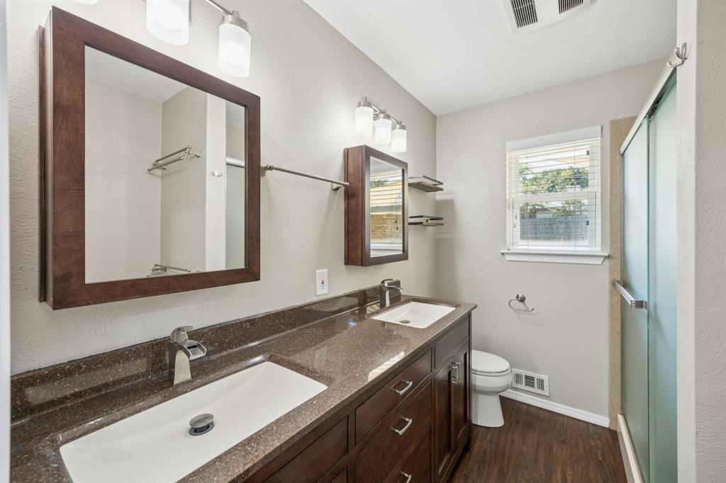 9536 Millridge Drive Dallas, TX 75243 - Photo 30 of 33 a bathroom with a sink and a mirror