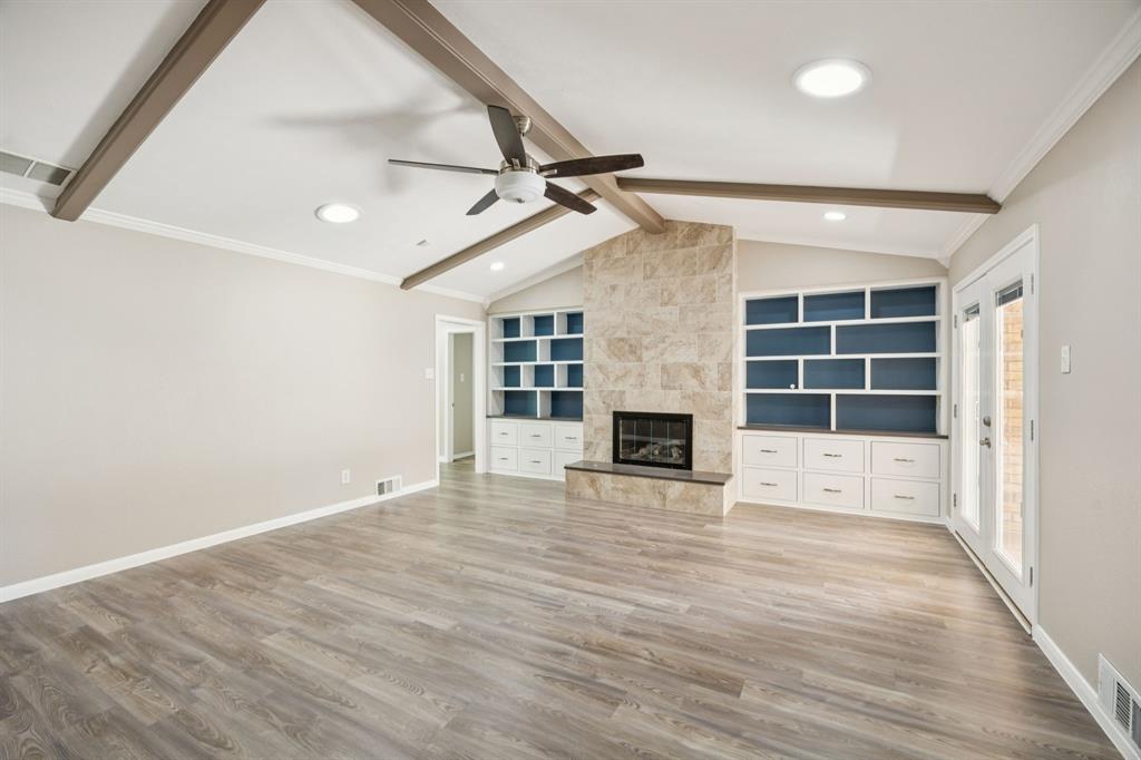 9536 Millridge Drive Dallas, TX 75243 - Photo 4 of 33 an empty room with windows and fireplace