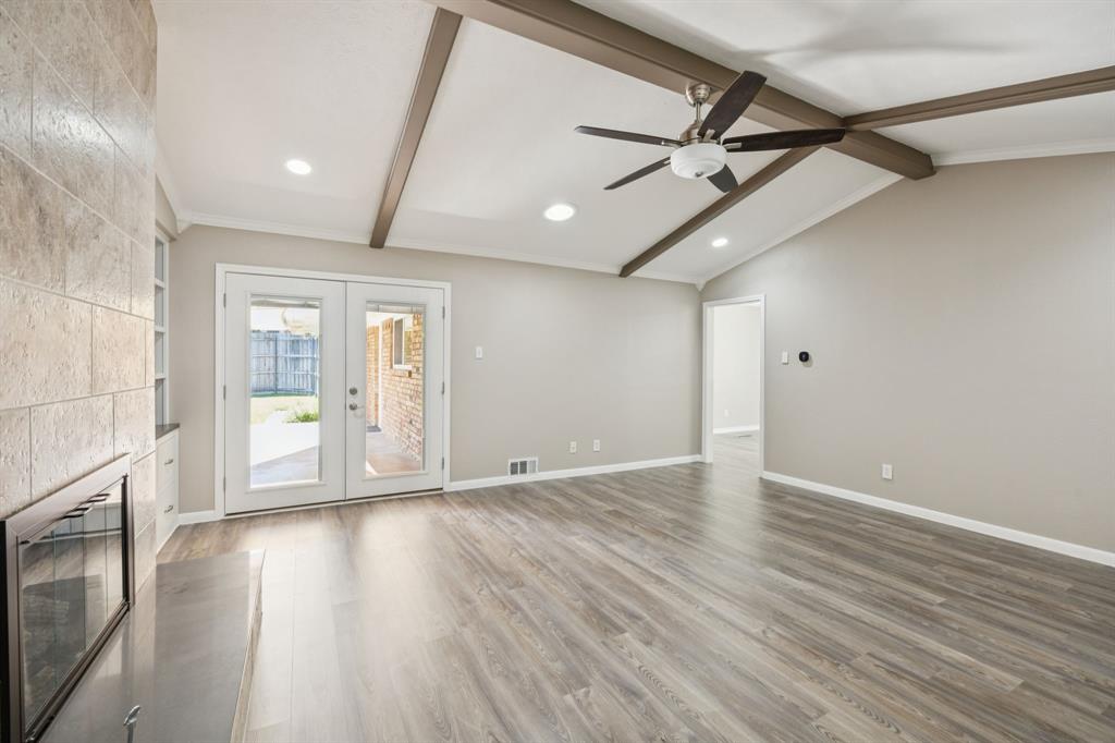 9536 Millridge Drive Dallas, TX 75243 - Photo 6 of 33 a view of an empty room with wooden floor and a window