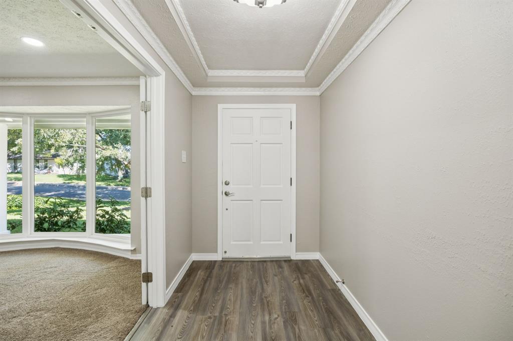 9536 Millridge Drive Dallas, TX 75243 - Photo 9 of 33 an empty room with wooden floor and windows