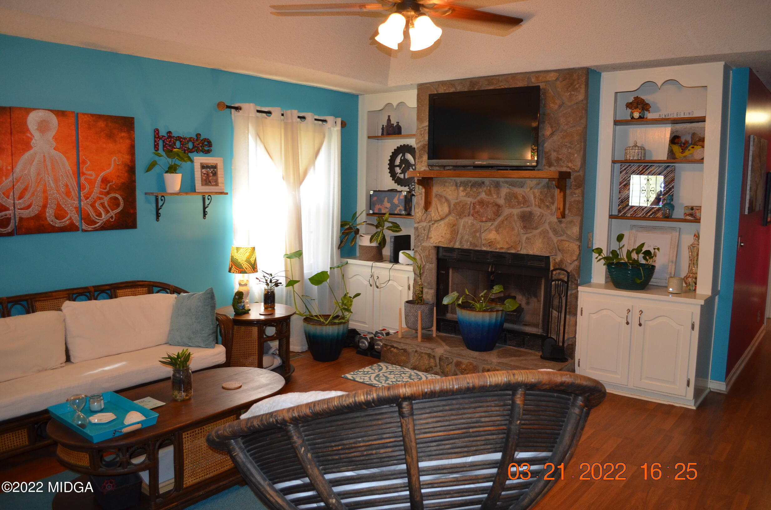 1167 Ridgeview Circle Macon, GA 31220 - Photo 4 of 26 a living room with furniture a flat screen tv and a fireplace