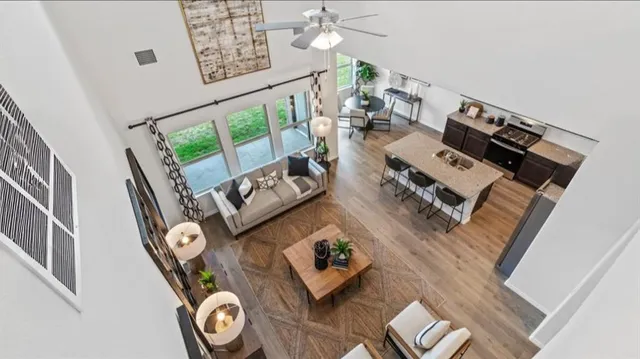 a living room with furniture and a dining table with wooden floor