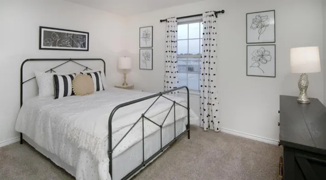 a bedroom with a bed and a wall painting