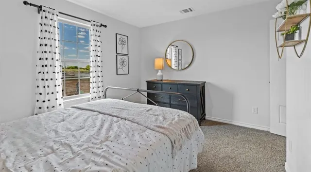 a bedroom with a bed and cabinet