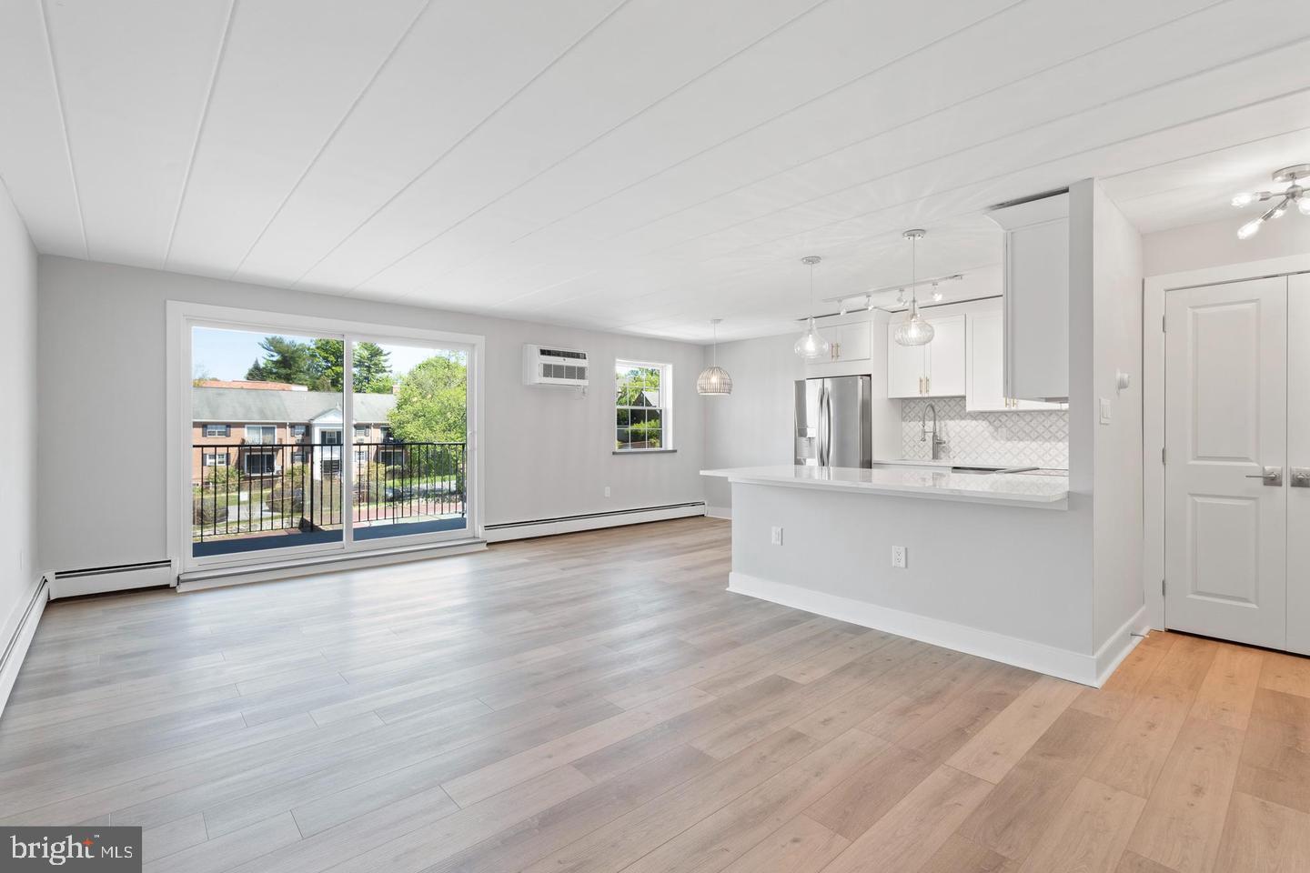 100 Windermere Avenue, Unit 301 Wayne, PA 19087 - Photo 1 of 6 a view of large kitchen with wooden floor and windows