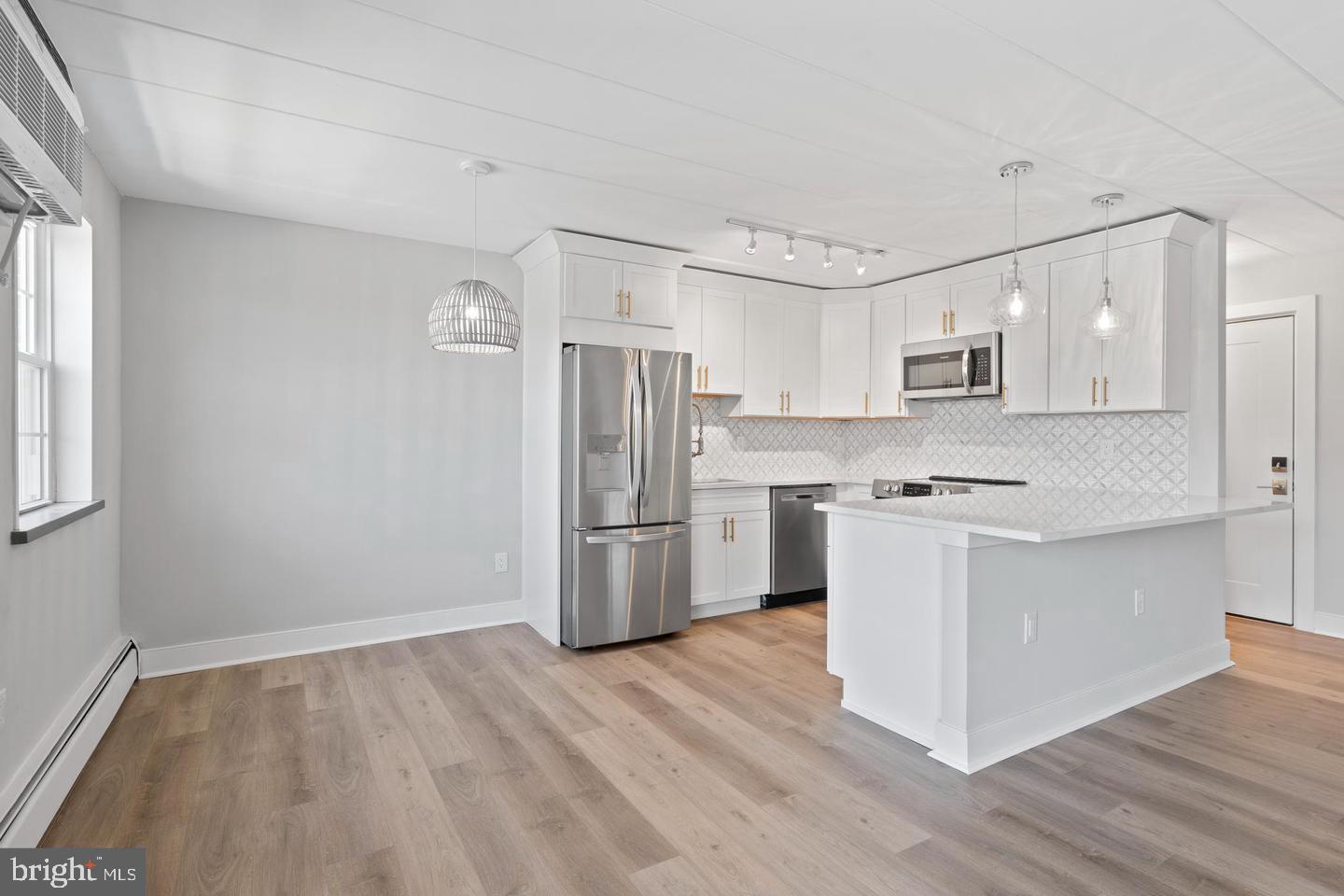 100 Windermere Avenue, Unit 301 Wayne, PA 19087 - Photo 3 of 6 a kitchen with a refrigerator cabinets and wooden floor