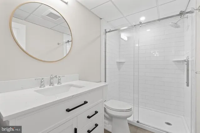 a bathroom with a sink a toilet and a mirror