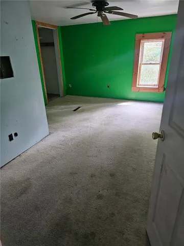 a view of a room with a window and a ceiling fan