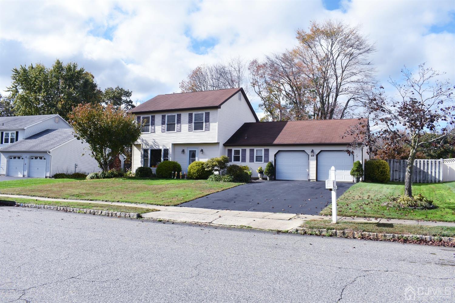 65 Higgins Road Old Bridge, NJ 08857 - Photo 22 of 22 a front view of a house with a yard and a garage