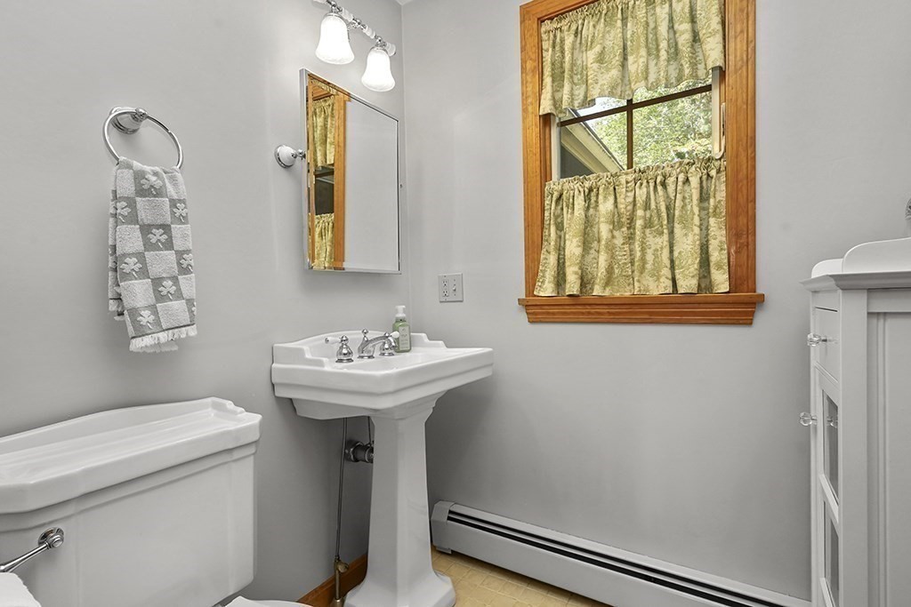 6 Lydia Lane Franklin, MA 02038 - Photo 26 of 42 a bathroom with a sink and mirror with toilet