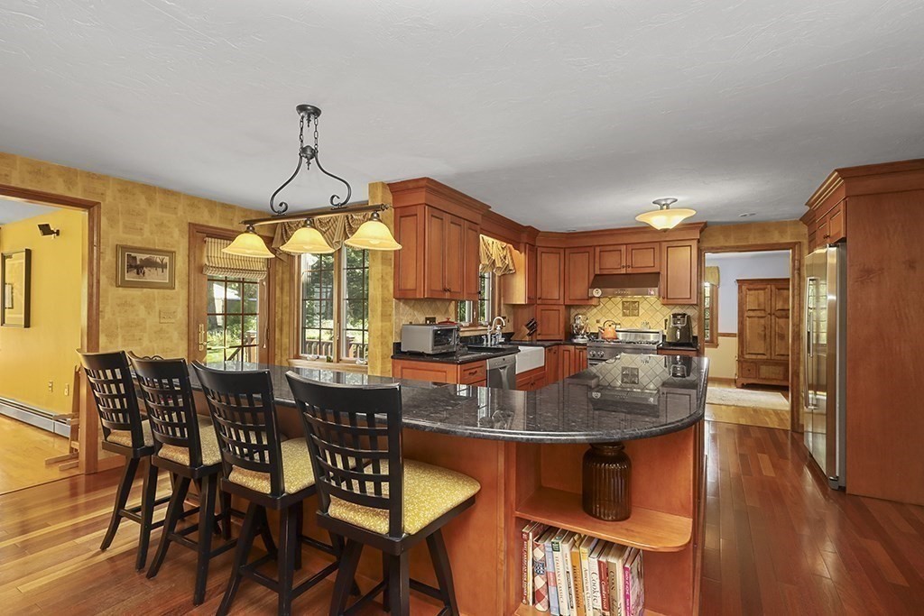 6 Lydia Lane Franklin, MA 02038 - Photo 27 of 42 a dining room with furniture a chandelier and wooden floor