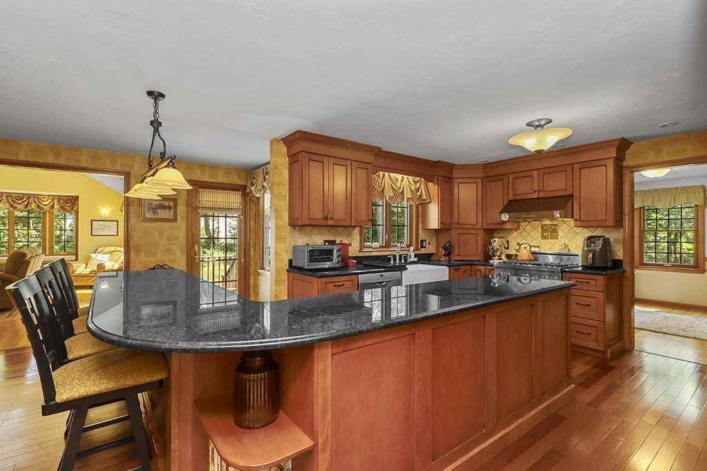 6 Lydia Lane Franklin, MA 02038 - Photo 28 of 42 a kitchen with stainless steel appliances granite countertop a kitchen island a stove a table and chairs