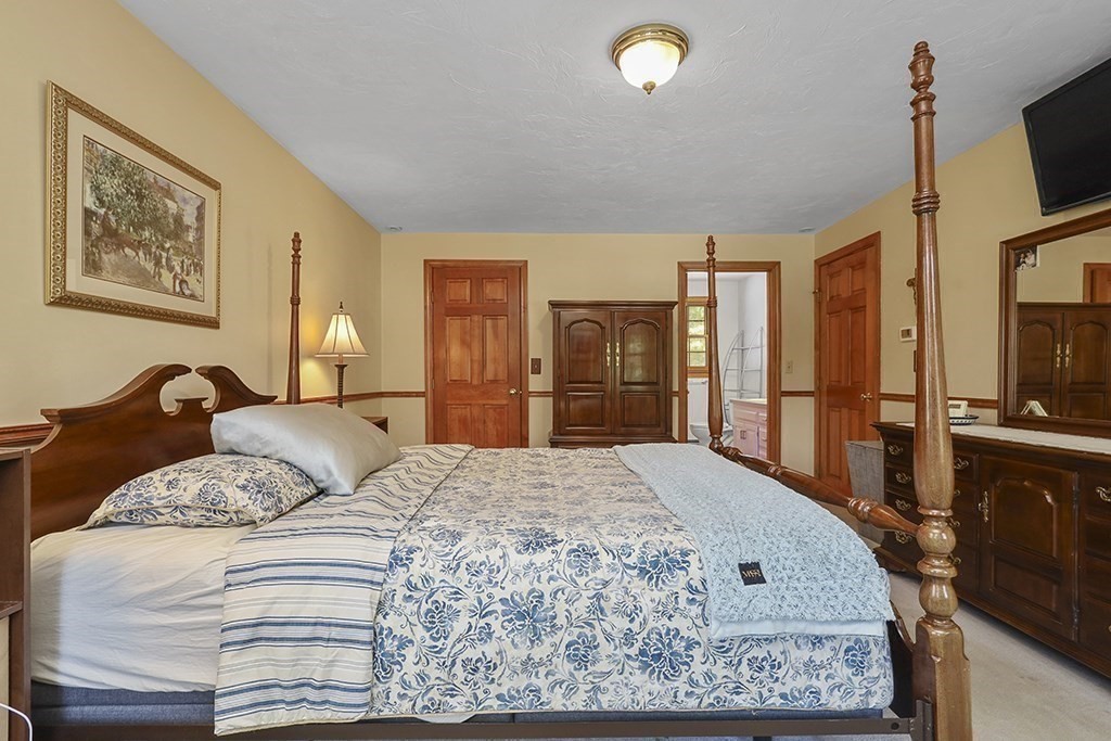 6 Lydia Lane Franklin, MA 02038 - Photo 39 of 42 a bedroom with a large bed and a flat screen tv