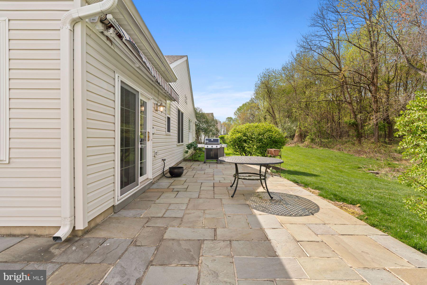 20 Black Eyed Susan Road Langhorne, PA 19047 - Photo 25 of 29 a view of a patio with a table and chairs and potted plants