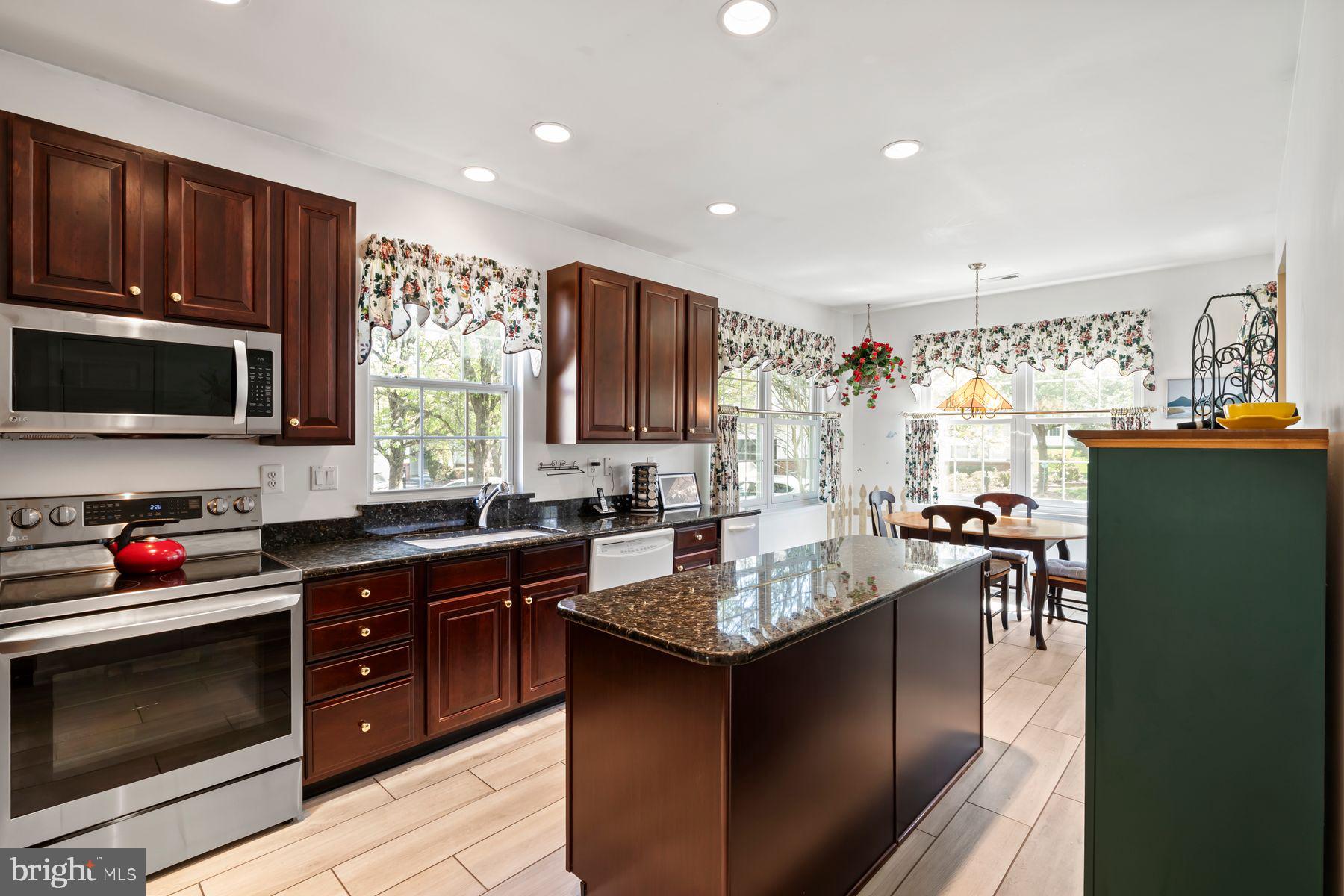 20 Black Eyed Susan Road Langhorne, PA 19047 - Photo 5 of 29 a kitchen with a sink stove and microwave