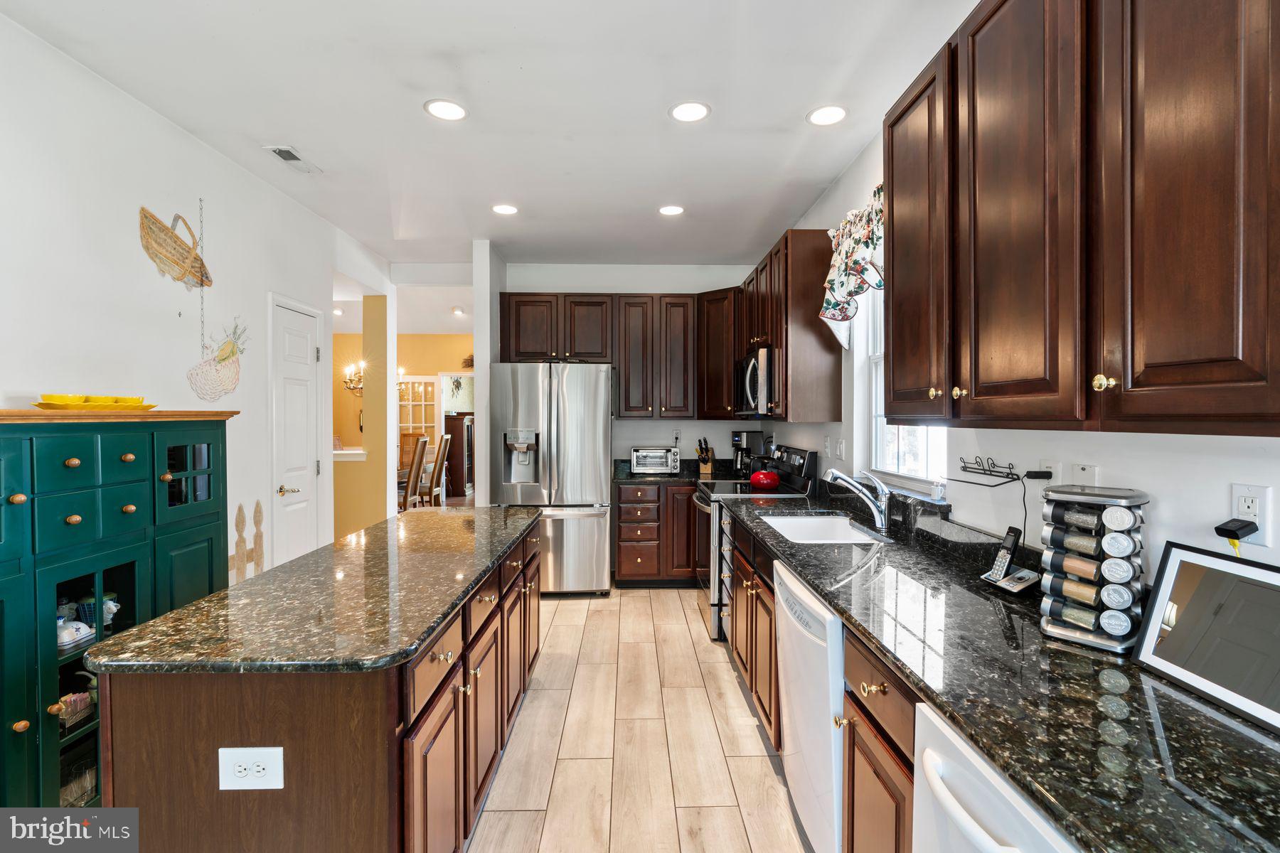 20 Black Eyed Susan Road Langhorne, PA 19047 - Photo 7 of 29 a kitchen with stainless steel appliances granite countertop sink stove refrigerator and cabinets