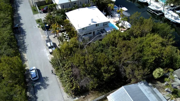an aerial view of a house with a yard and garden