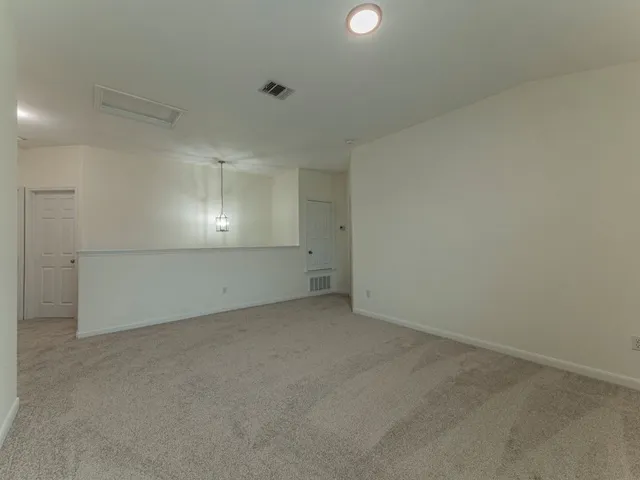a view of a livingroom with a ceiling fan and window
