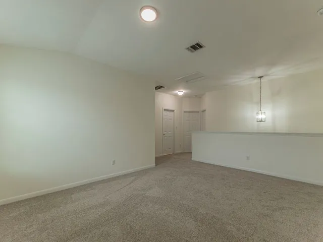 a view of a backyard with potted plants and wooden fence
