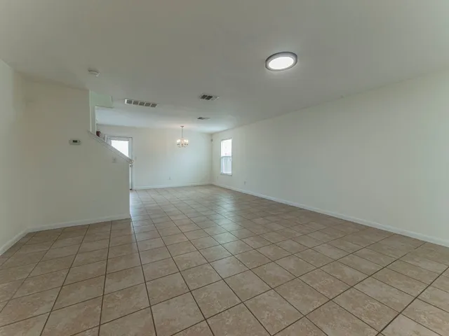 a view of a kitchen with a sink and a chandelier