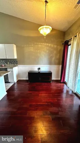 a view of a livingroom with furniture window and wooden floor