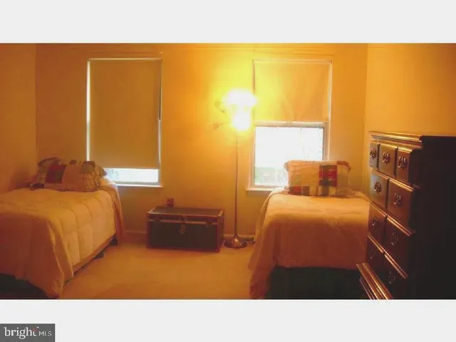 a living room with a bed furniture and a window