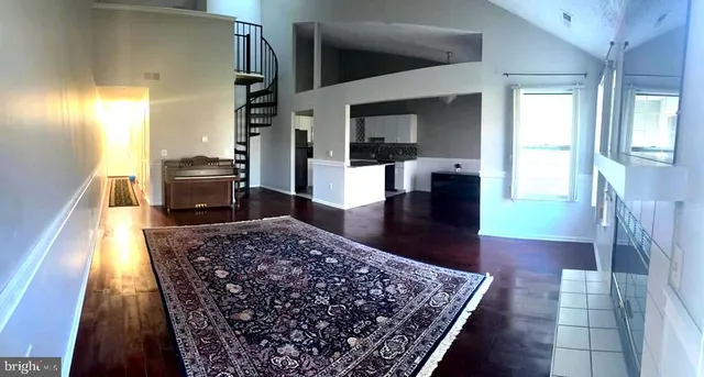 a living room with a rug and a couch