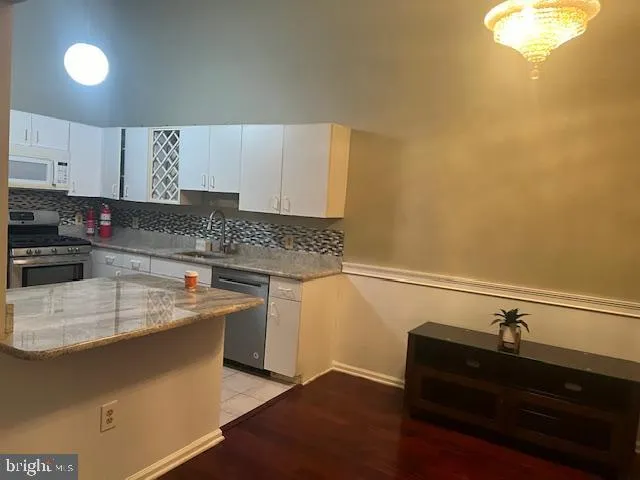 a kitchen with a sink and cabinets