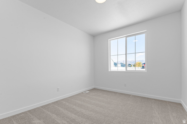 3016 West 2650 North Clinton, UT 84015 - Photo 10 of 20 Unfurnished room with light carpet and baseboards