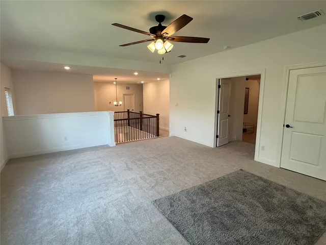 a view of staircase with lots of frames on wall and windows