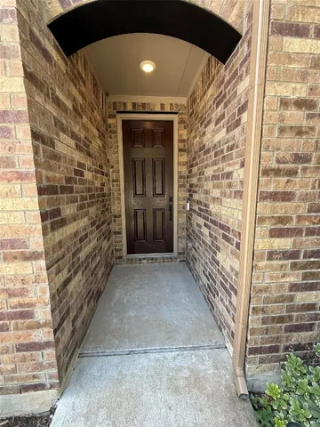 a kitchen with a dining table chairs and refrigerator