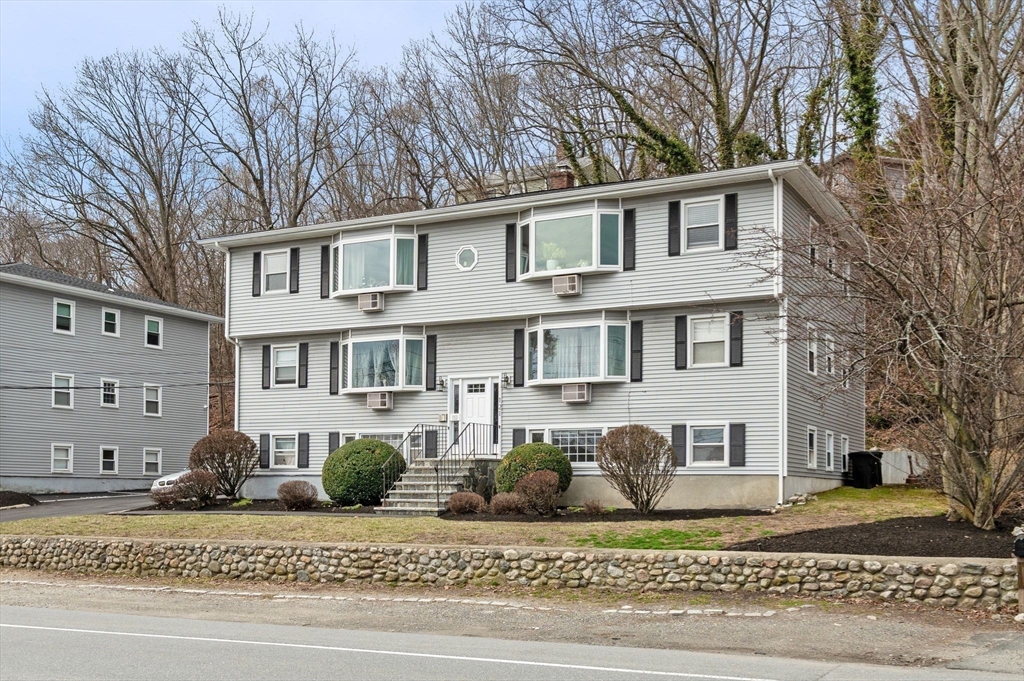 121 Cambridge Road, Unit 2 Woburn, MA 01801 - Photo 22 of 23 a front view of a house with a yard