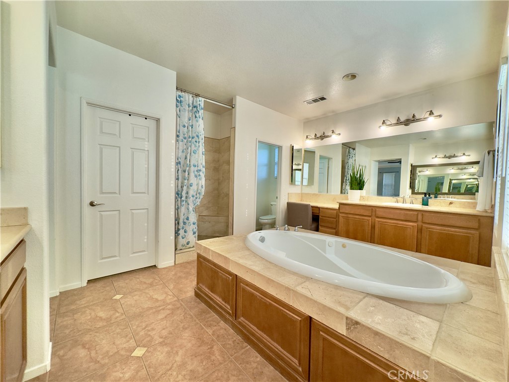 11265 Runyan Road Beaumont, CA 92223 - Photo 89 of 138 Grand Primary Bedroom Suite Bathroom with large soaking tub, separate vanities, water closet, and large walk-in closet and shower.