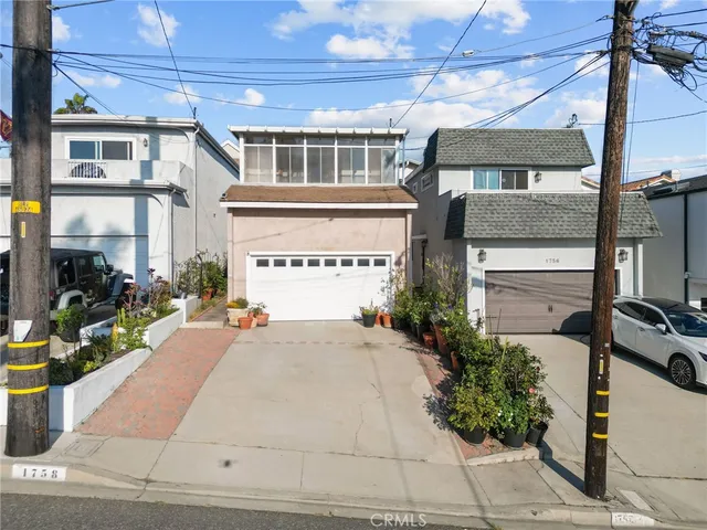 a front view of a building with potted plants