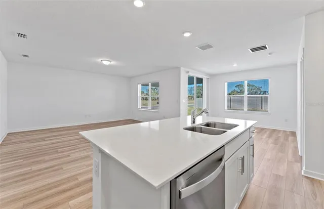 a kitchen that has a sink and a table in it